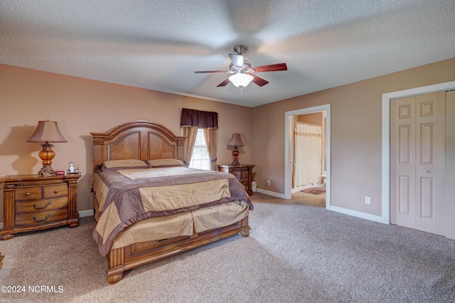 bedroom featuring ensuite bath, ceiling fan, light carpet, and a textured ceiling