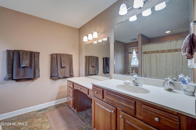 bathroom with vanity and a textured ceiling