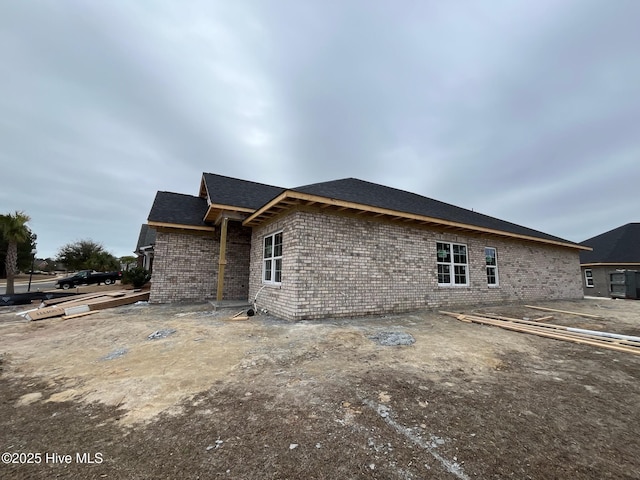 rear view of property with brick siding