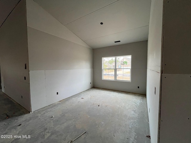 spare room with lofted ceiling