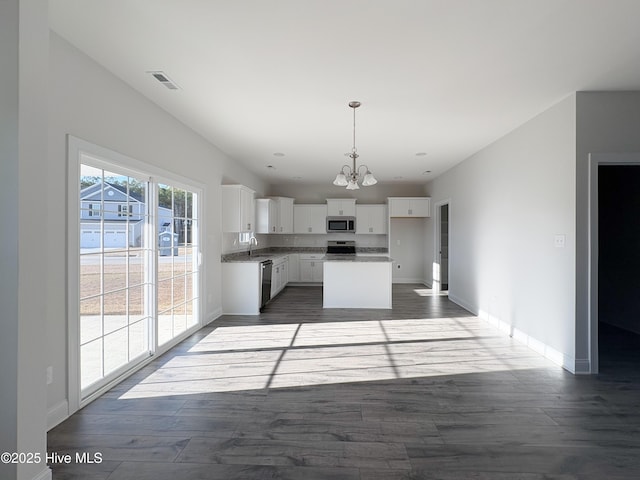 kitchen featuring a kitchen island, sink, white cabinets, a chandelier, and stainless steel appliances