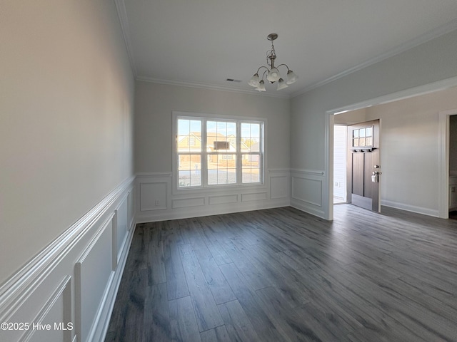 unfurnished room with ornamental molding, dark wood-type flooring, and a notable chandelier