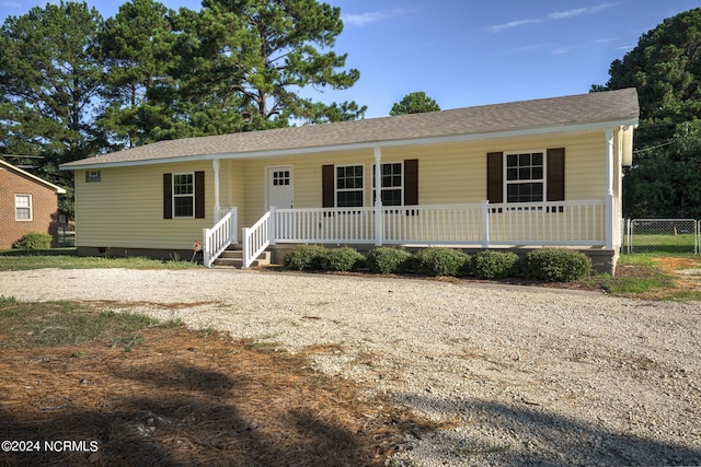 view of front of property with a shingled roof, covered porch, and crawl space