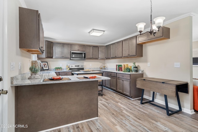 kitchen with appliances with stainless steel finishes, crown molding, light wood-type flooring, and a notable chandelier