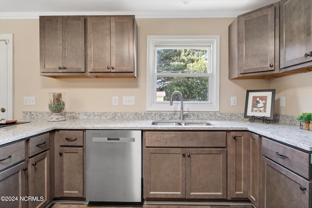 kitchen with dishwasher, sink, light stone counters, and crown molding