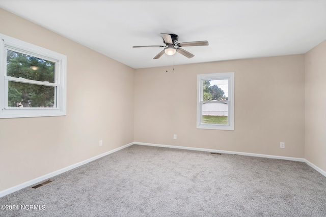 empty room with ceiling fan and carpet floors