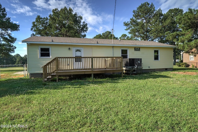 back of house with a lawn and a wooden deck