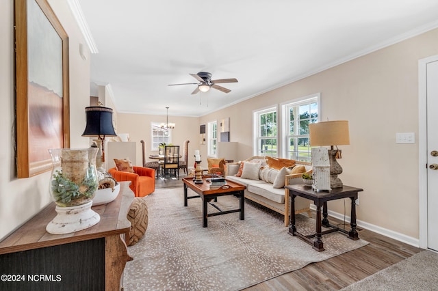 living room with crown molding, ceiling fan with notable chandelier, and hardwood / wood-style floors