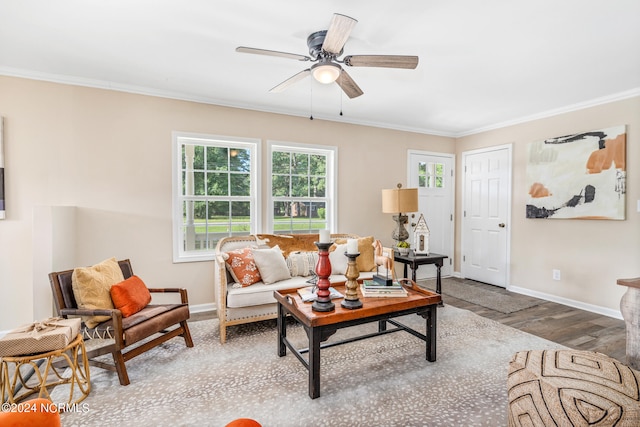 living room with ornamental molding, wood-type flooring, and ceiling fan