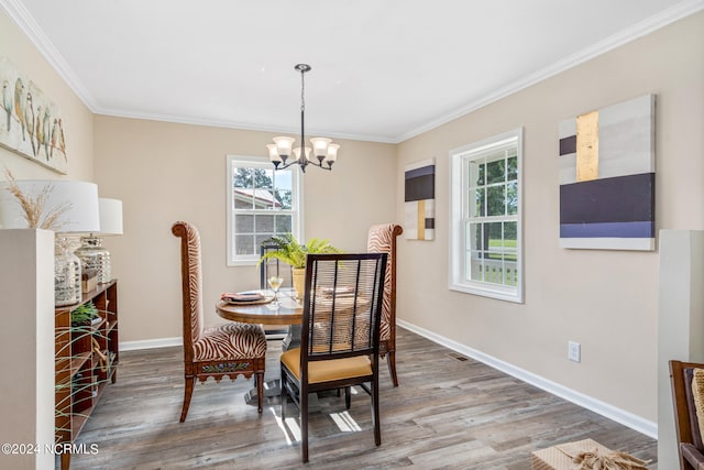 dining room with a chandelier, hardwood / wood-style flooring, and crown molding