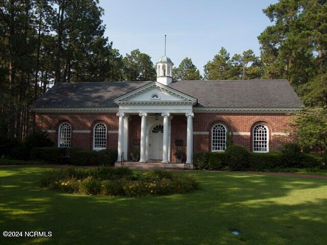 neoclassical / greek revival house with a front yard