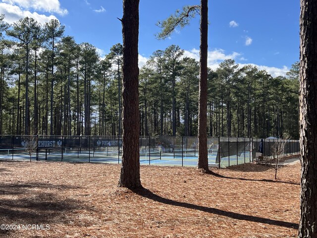 view of property's community featuring tennis court