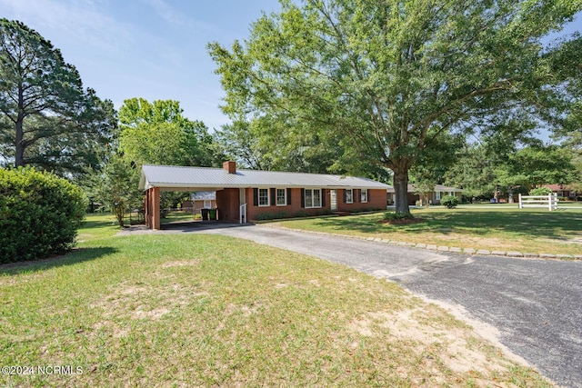 ranch-style house with a front lawn and a carport