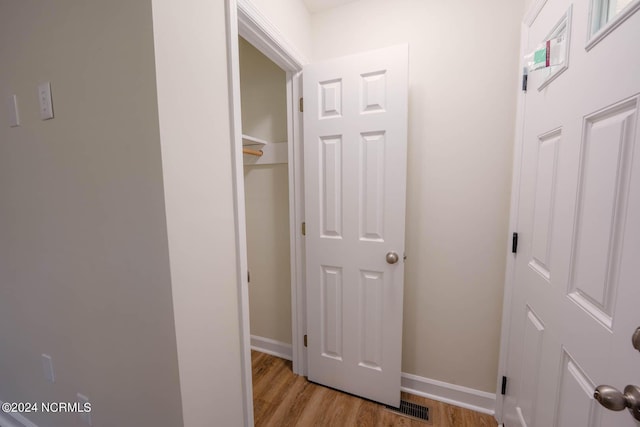 corridor with light wood-type flooring