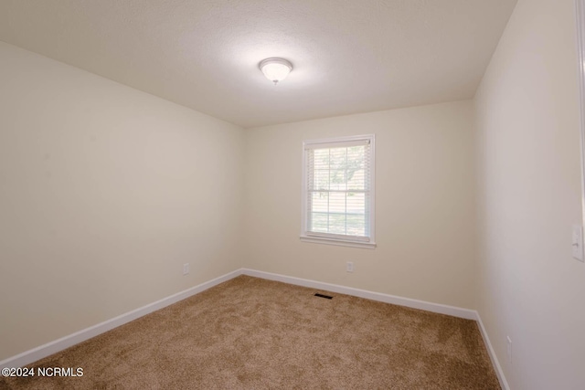 unfurnished room featuring carpet