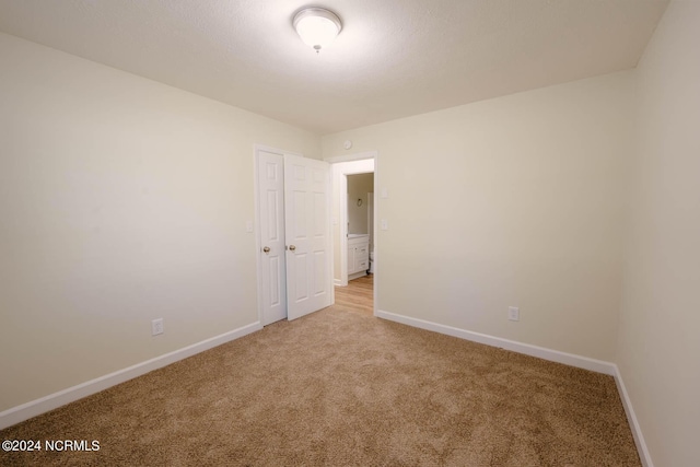 empty room featuring light colored carpet