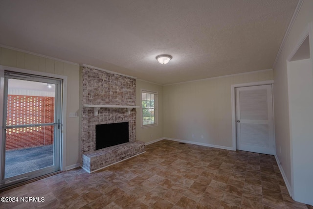 unfurnished living room with ornamental molding, a textured ceiling, and a brick fireplace