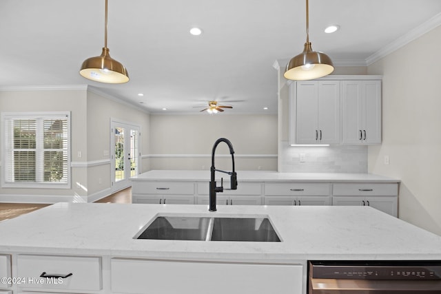 kitchen featuring white cabinets, dishwasher, crown molding, french doors, and a sink