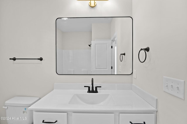 bathroom featuring toilet and vanity