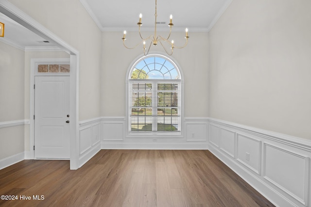 unfurnished dining area with dark hardwood / wood-style flooring, a notable chandelier, and crown molding