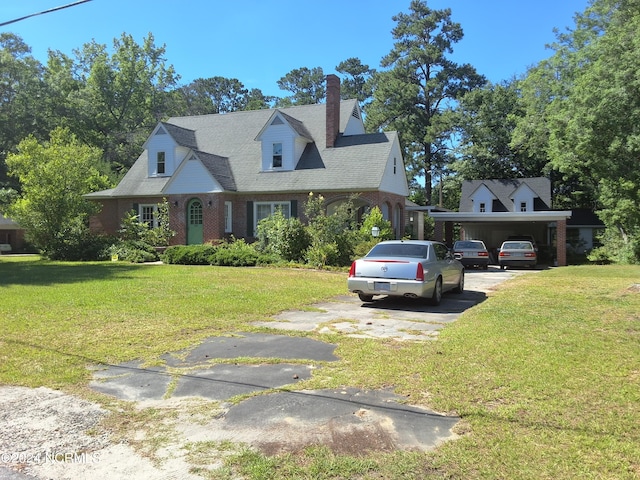 cape cod home featuring a front yard and a carport