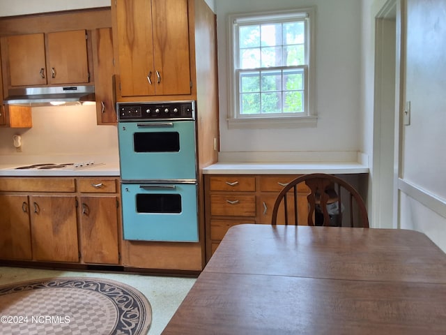 kitchen with white gas cooktop and multiple ovens