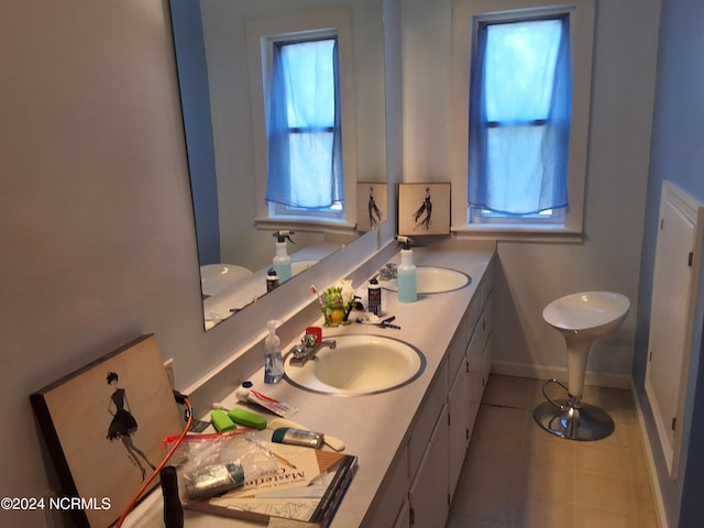 bathroom with vanity, a healthy amount of sunlight, and toilet