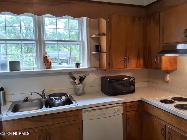 kitchen with white appliances, sink, and exhaust hood