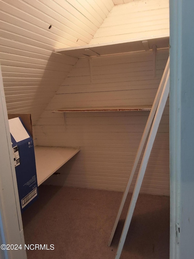 walk in closet featuring vaulted ceiling