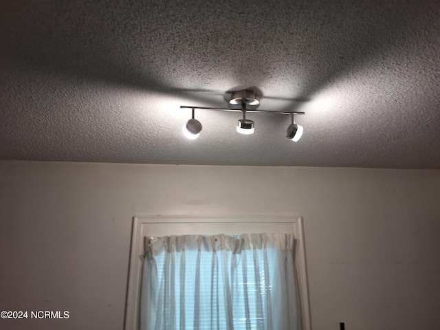 interior details featuring a textured ceiling