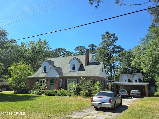 cape cod-style house featuring a front lawn and a carport