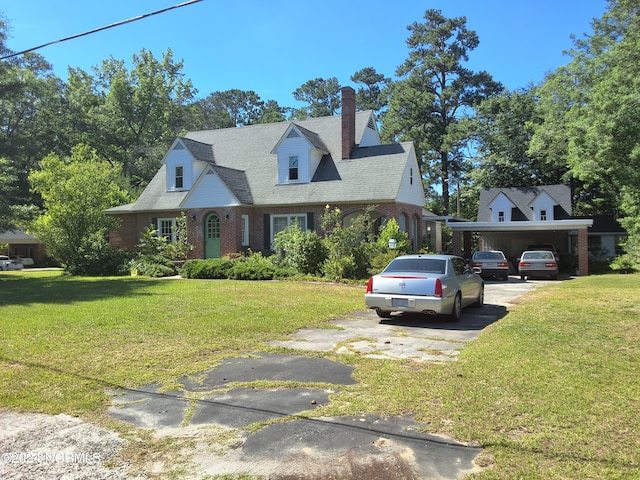 cape cod home with a front yard and a carport