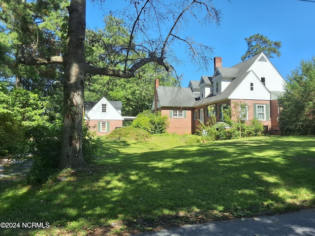 view of side of property with a yard