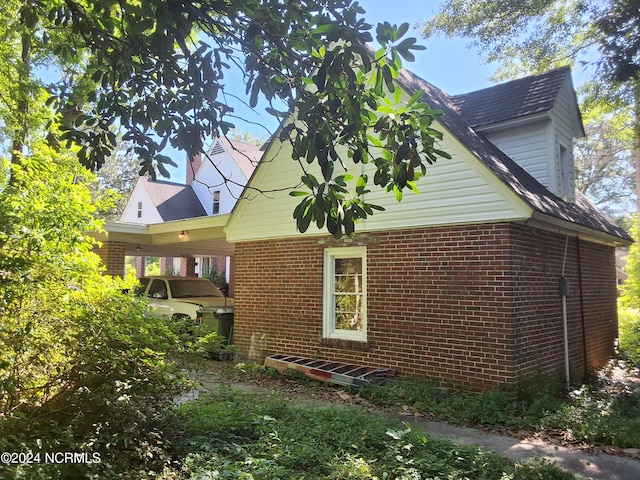 view of property exterior with a carport