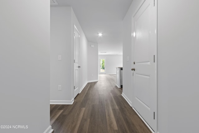 corridor featuring dark hardwood / wood-style flooring