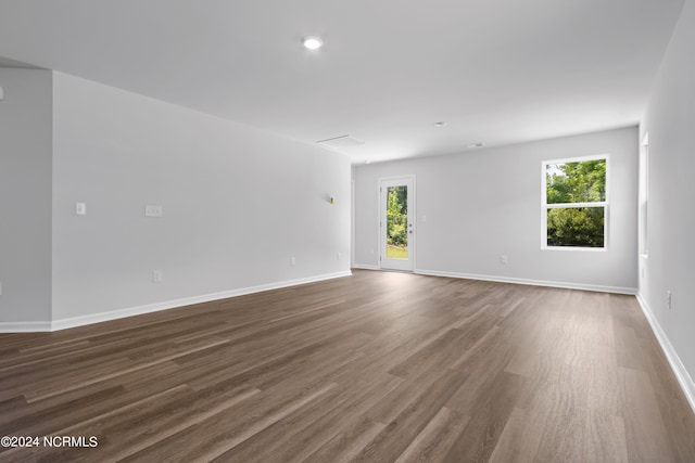 unfurnished room featuring dark wood-type flooring