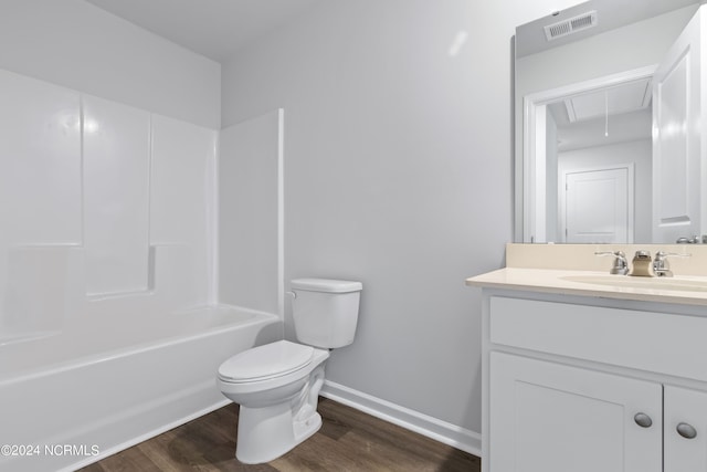 full bathroom with hardwood / wood-style floors, vanity, bathtub / shower combination, and toilet