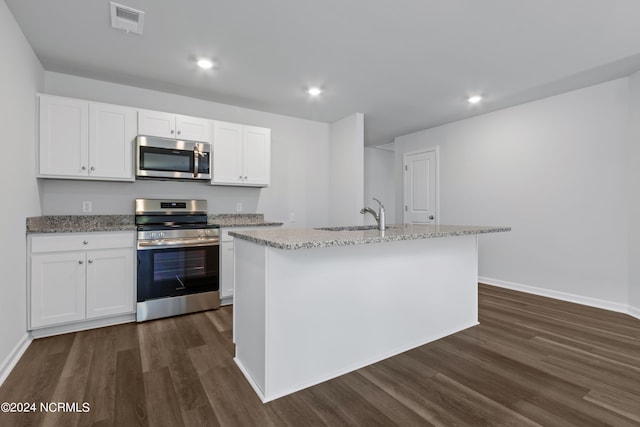 kitchen with white cabinets, stainless steel appliances, and a kitchen island with sink