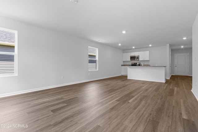 unfurnished living room with hardwood / wood-style floors