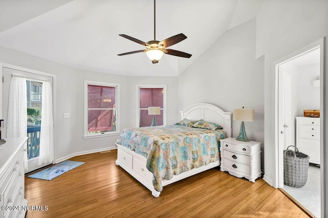 bedroom featuring vaulted ceiling, light wood-type flooring, and access to exterior