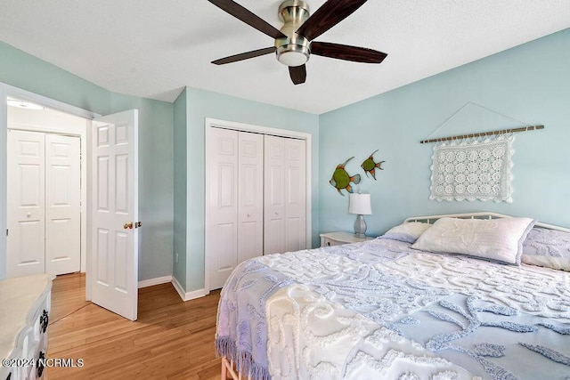 bedroom featuring light wood-style floors, a closet, ceiling fan, and baseboards