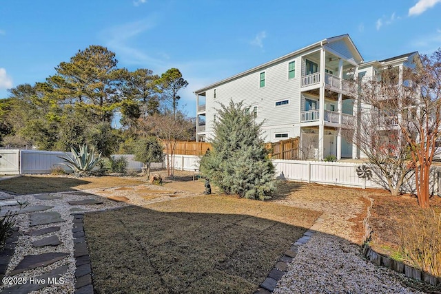 rear view of property featuring a fenced backyard