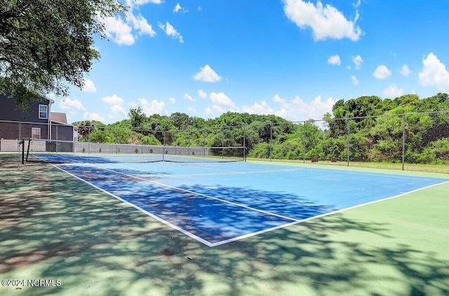 view of tennis court with fence