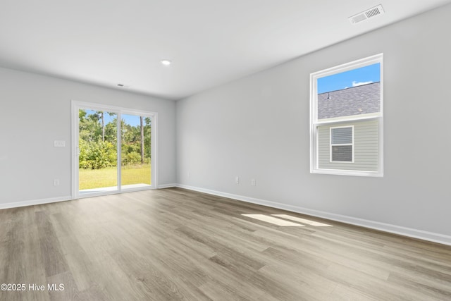 unfurnished room with light hardwood / wood-style flooring