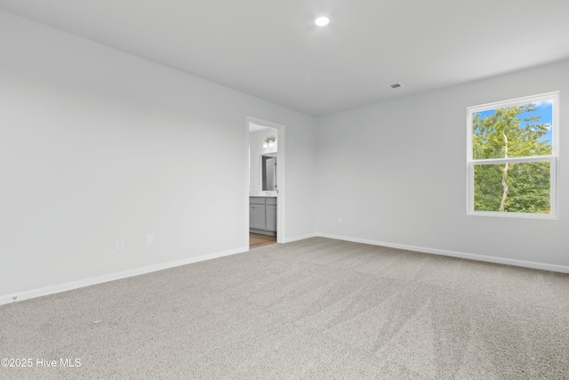 spare room with light carpet