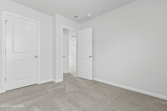 unfurnished bedroom with light colored carpet