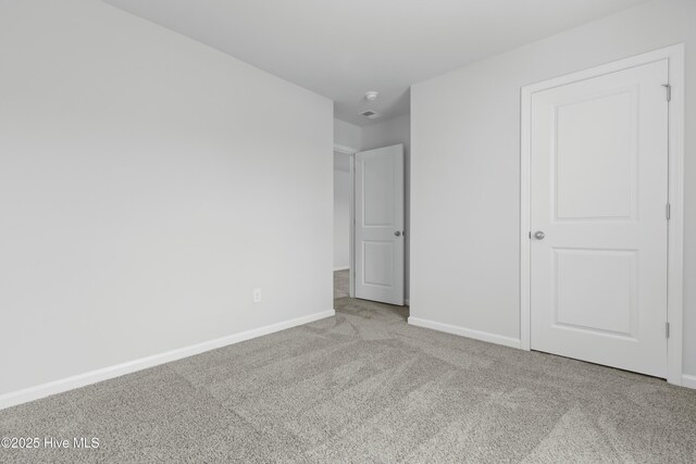 unfurnished room with light carpet