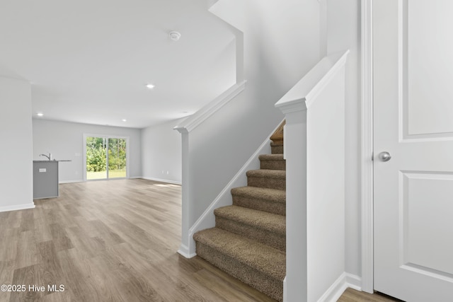 stairway featuring hardwood / wood-style floors