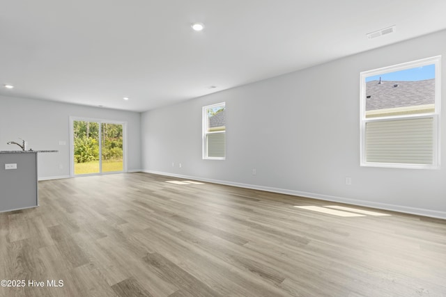 unfurnished room featuring sink and light wood-type flooring