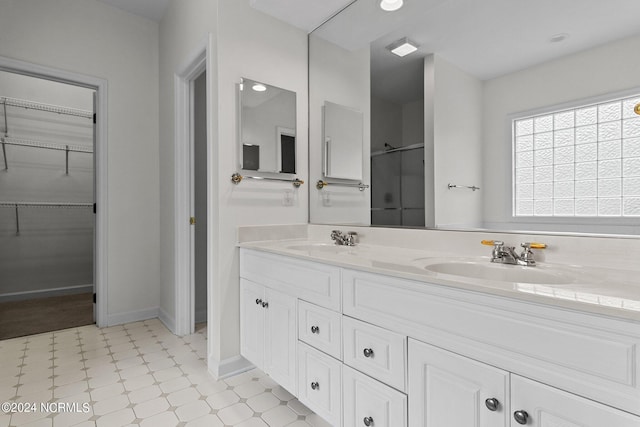 bathroom with vanity and a shower with shower door